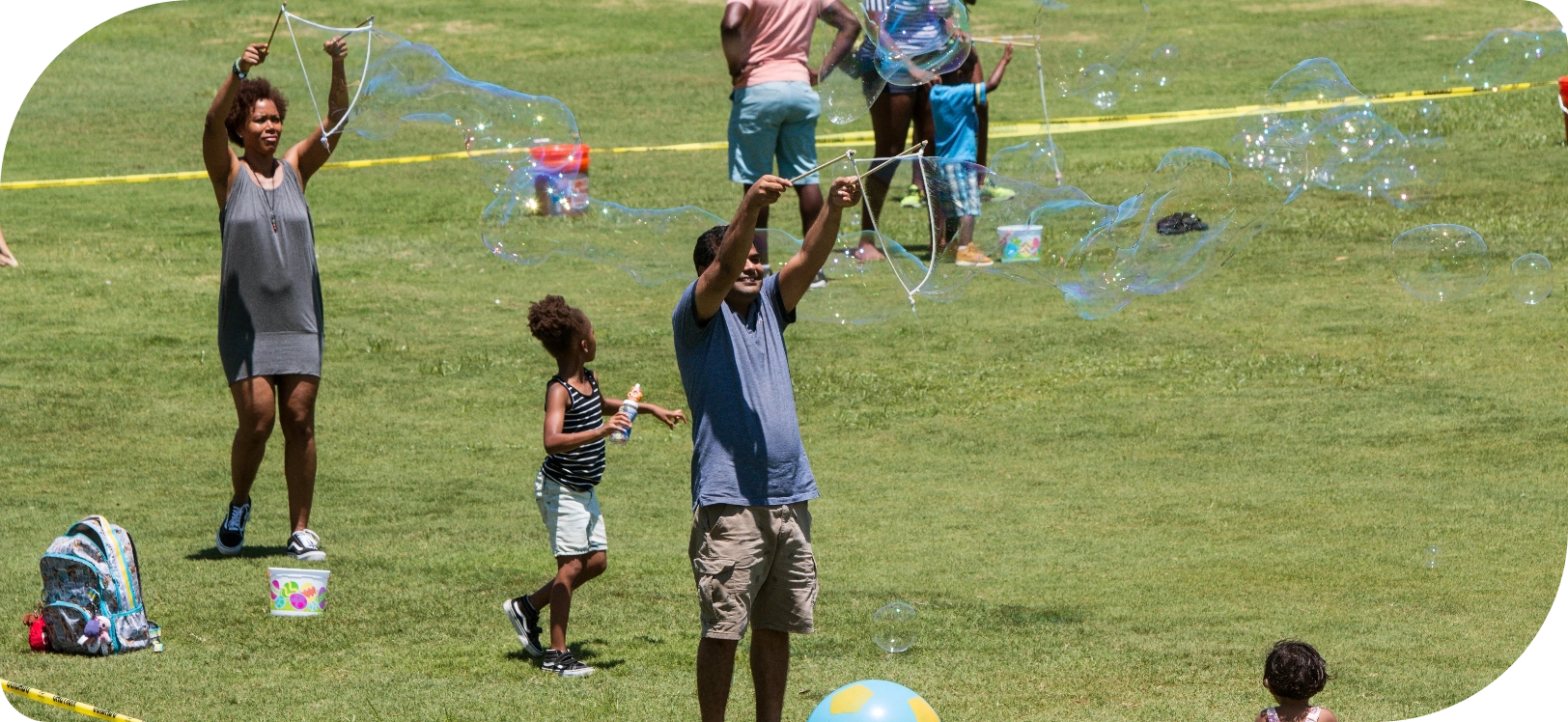 People in a park blowing bubbles